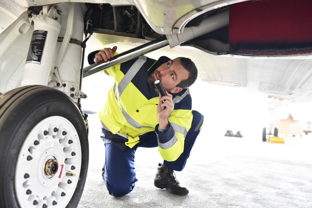 Aircraft mechanic student inspecting landing gear
