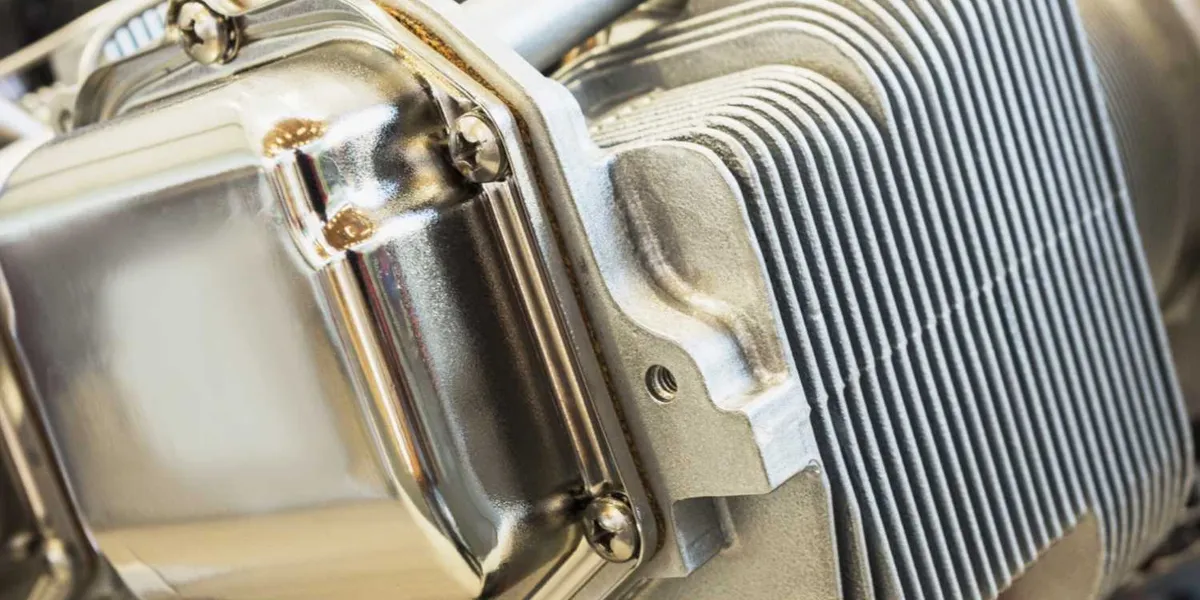 A close-up of a piston engine cylinder and valve cover, from The Grease Pilot Show cover art